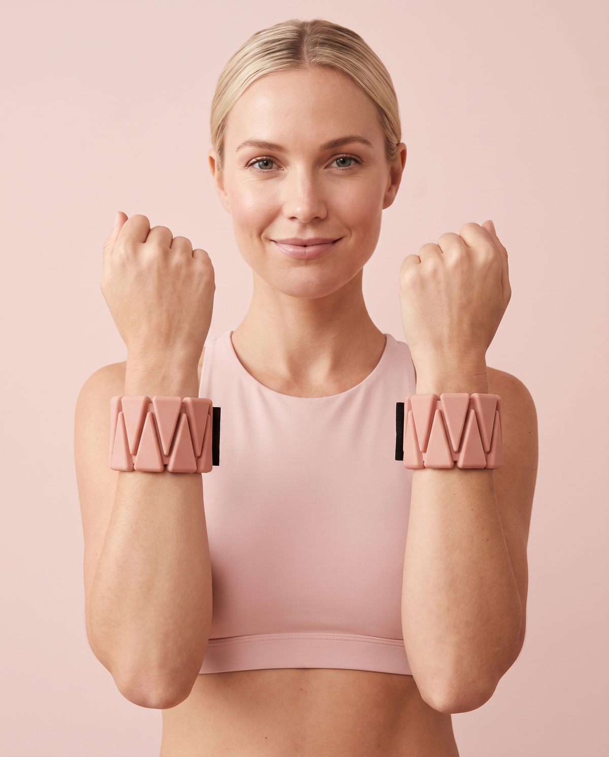 Woman in a blush pink sports bra wearing Dusty Pink SoftCore wrist weights